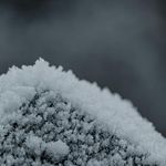 Macro texture of frost crystals on dark surface